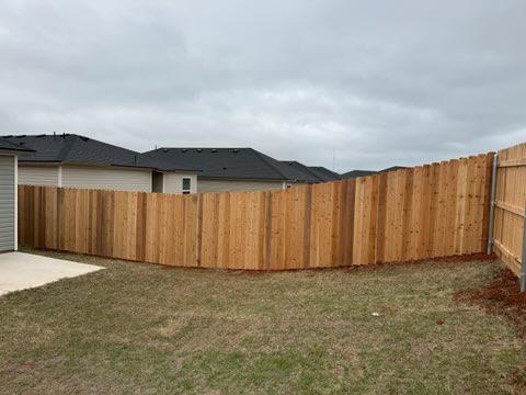 wood stockade fence installed by top rail fence