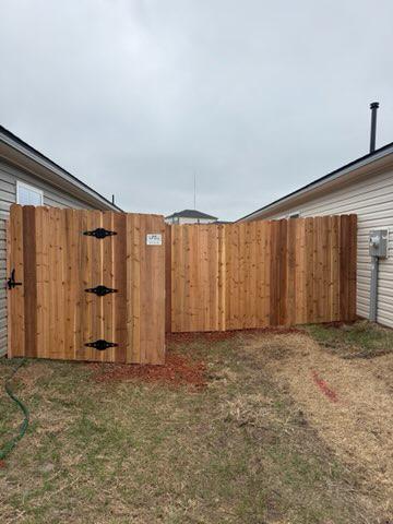 wood stockade fence installed by top rail fence