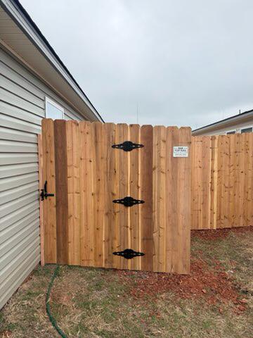 wood stockade fence installed by top rail fence
