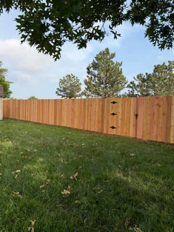 wood stockade fence installed by top rail fence