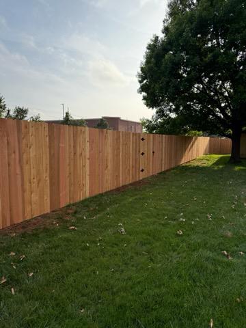 wood stockade fence installed by top rail fence