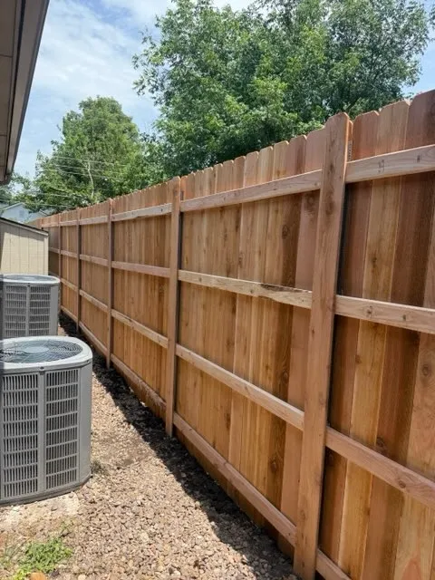 wood stockade fence installed by top rail fence