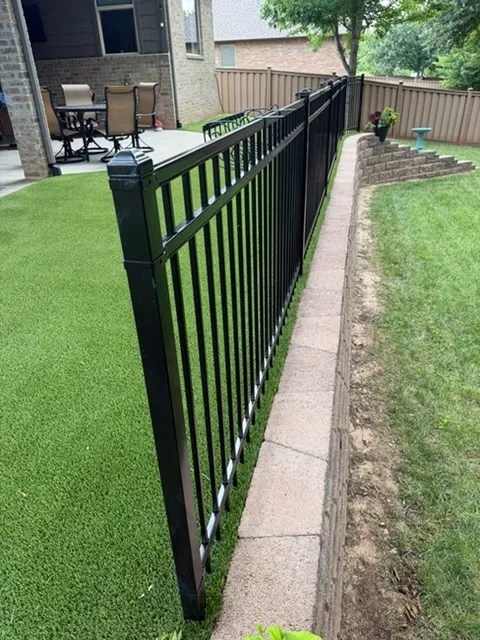 three rail ornamental metal fence installed by top rail fence