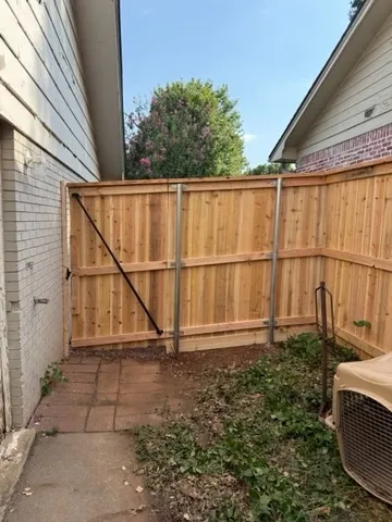 wood stockade fence installed by top rail fence