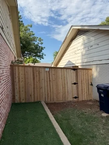 wood stockade fence installed by top rail fence