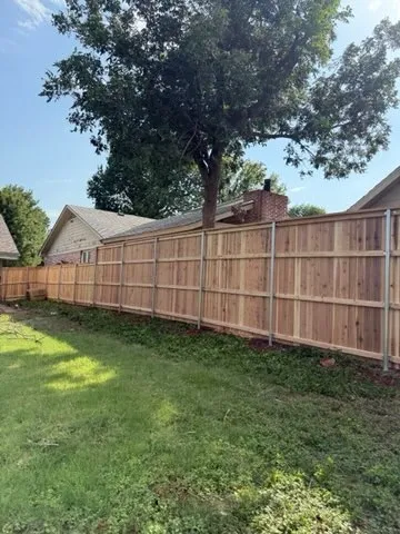 wood stockade fence installed by top rail fence