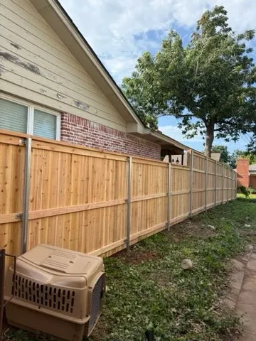 wood stockade fence installed by top rail fence