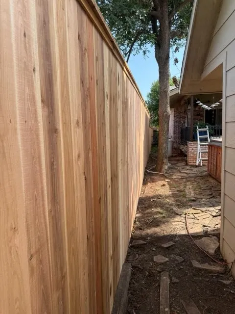 wood stockade fence installed by top rail fence