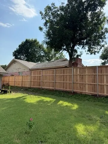 wood stockade fence installed by top rail fence