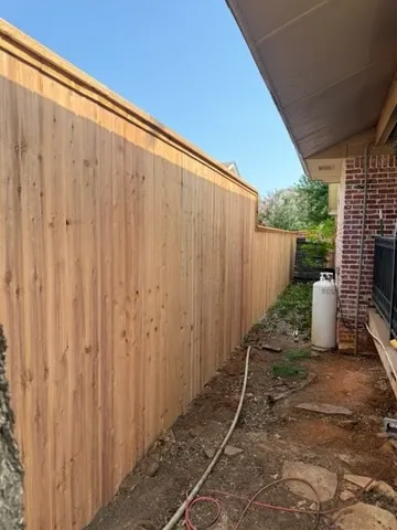 wood stockade fence installed by top rail fence