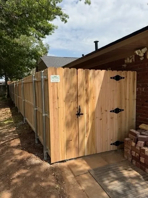 wood stockade fence installed by top rail fence