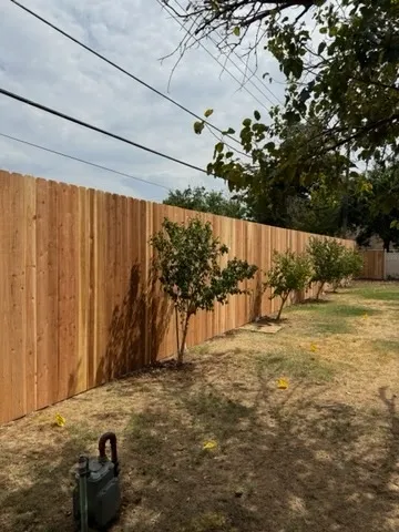 wood stockade fence installed by top rail fence