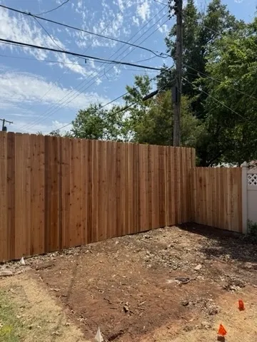 wood stockade fence installed by top rail fence