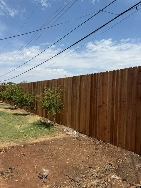 wood stockade fence installed by top rail fence