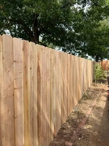 wood stockade fence installed by top rail fence