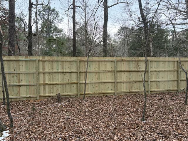 wood stockade fence installed by top rail fence