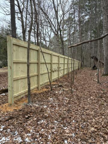 wood stockade fence installed by top rail fence