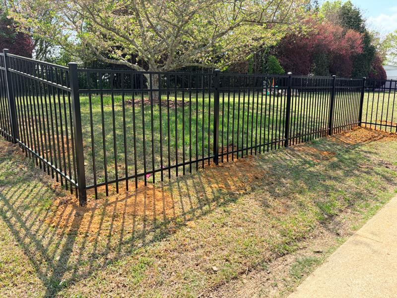 three rail ornamental metal fence installed by top rail fence