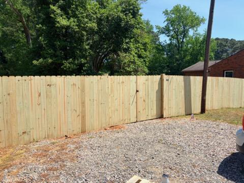 wood stockade fence installed by top rail fence