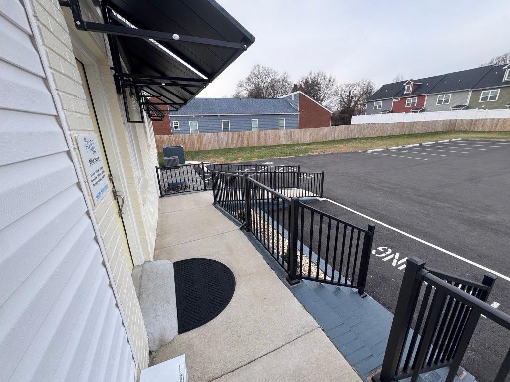 ornamental metal railing installed by top rail fence