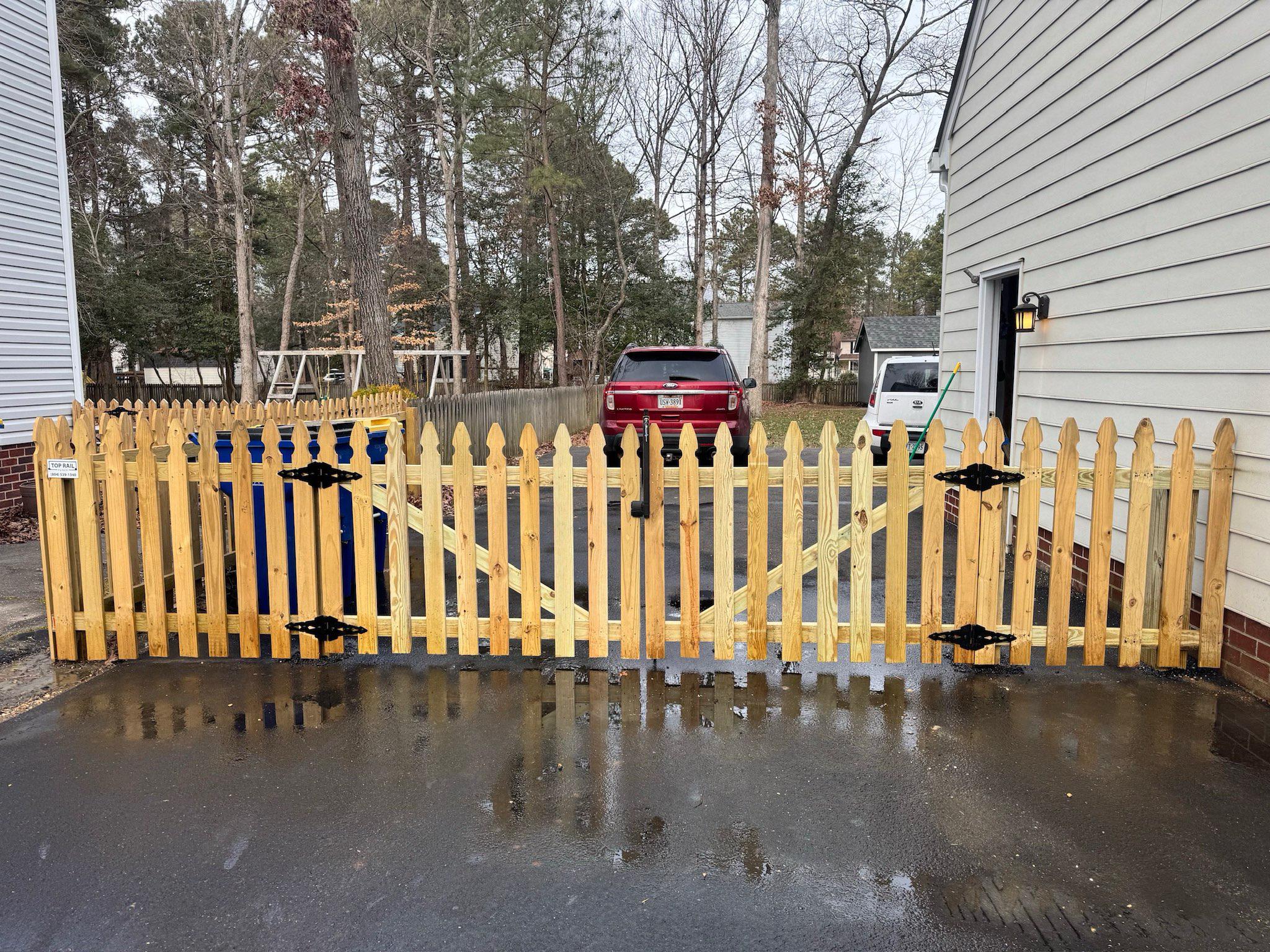 wood gate installed by top rail fence