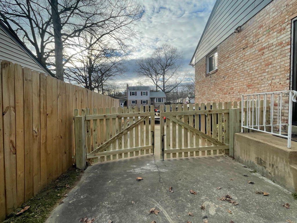 wood picket gate installed by top rail fence