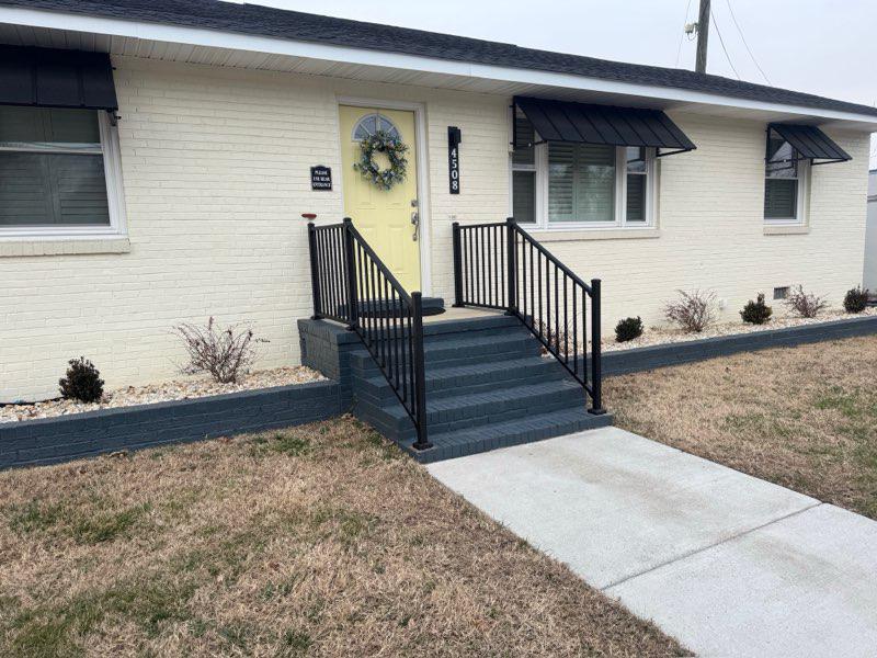 ornamental metal railing installed by top rail fence