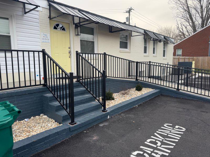 ornamental metal railing installed by top rail fence