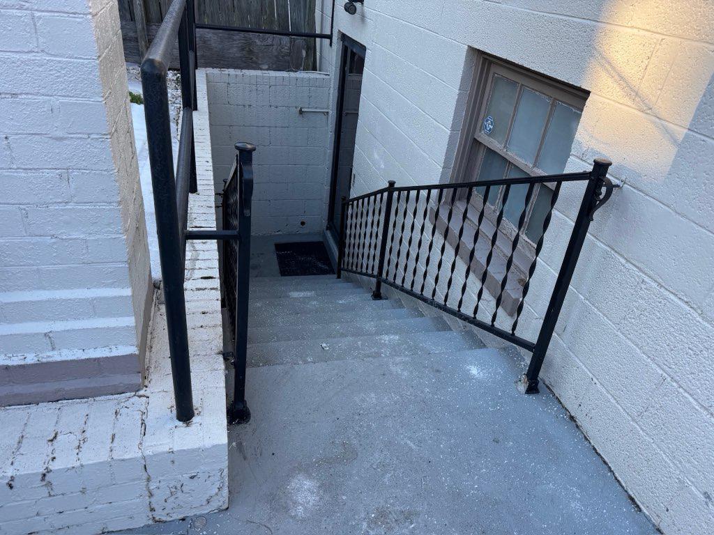 ornamental metal railing installed by top rail fence