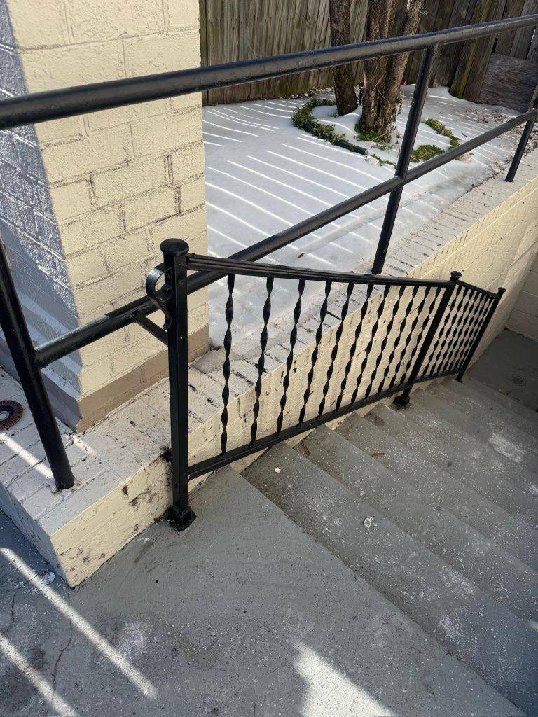 ornamental metal railing installed by top rail fence