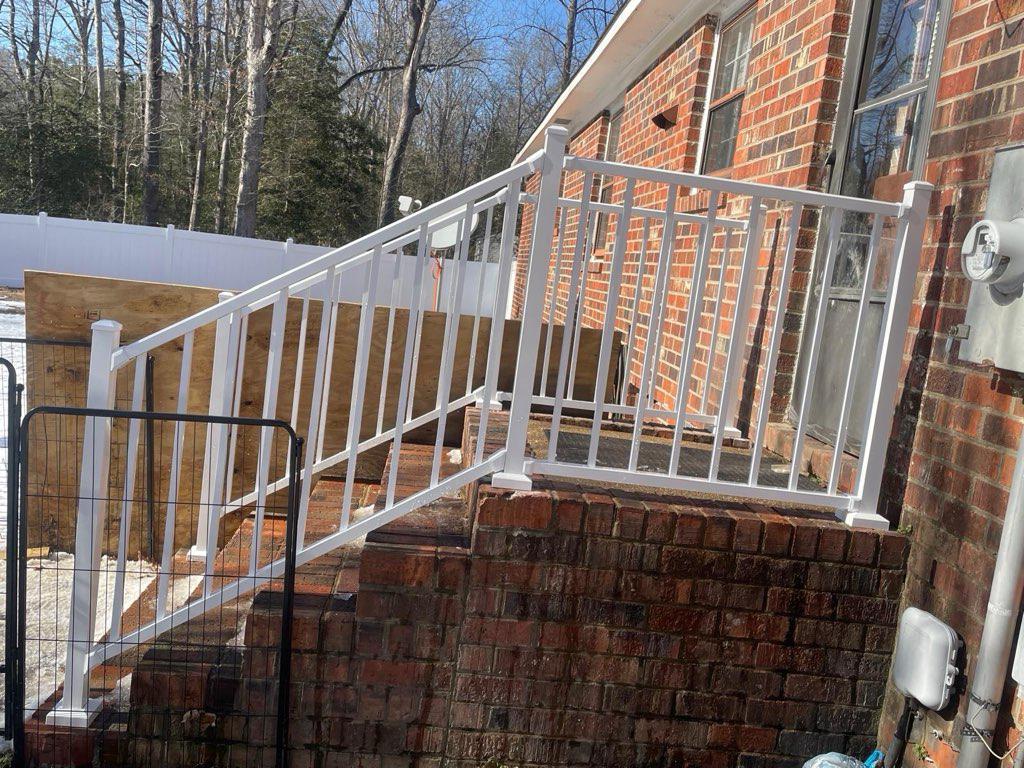 ornamental metal railing installed by top rail fence
