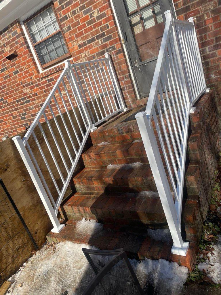 ornamental metal railing installed by top rail fence