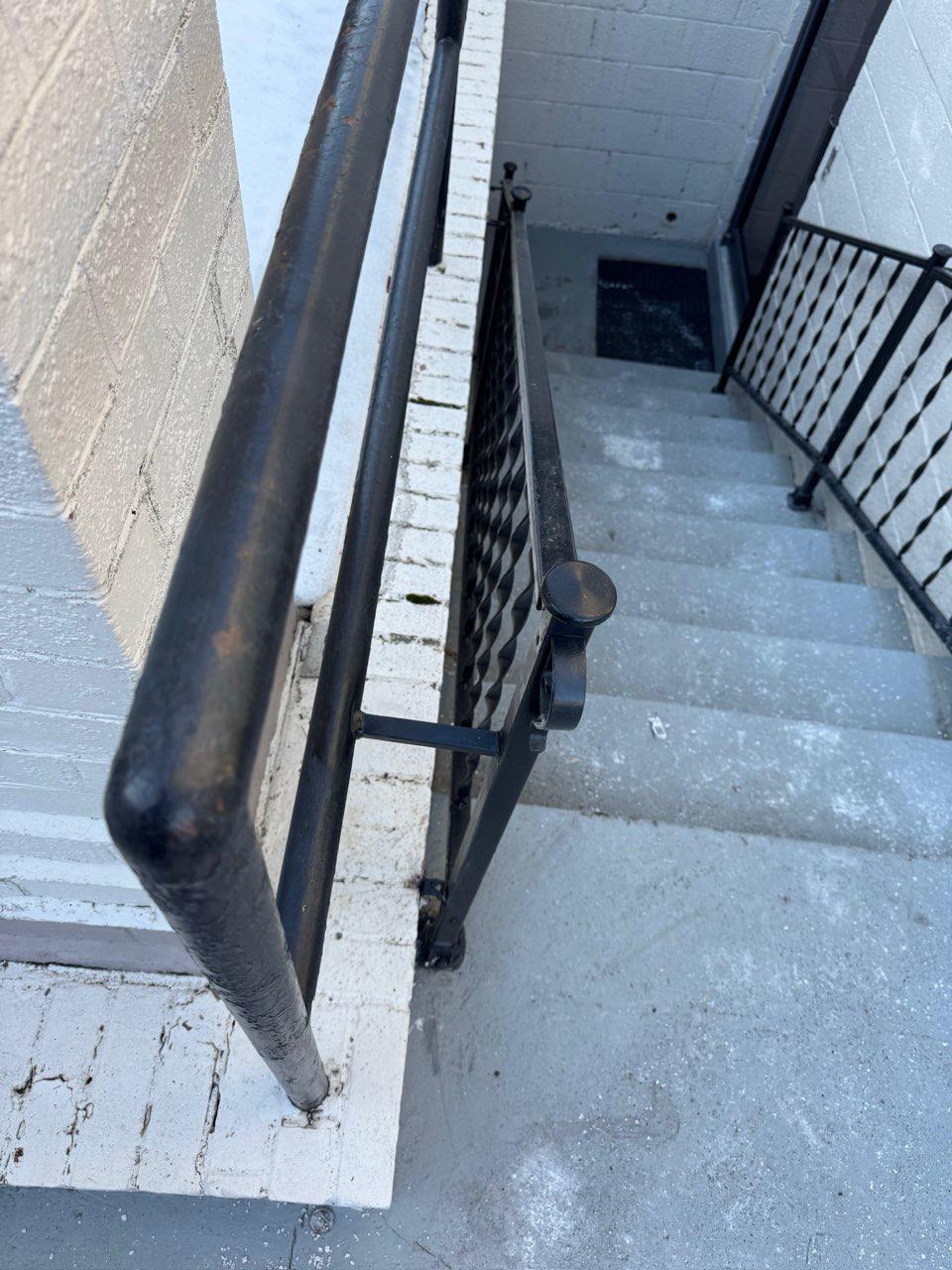 ornamental metal railing installed by top rail fence