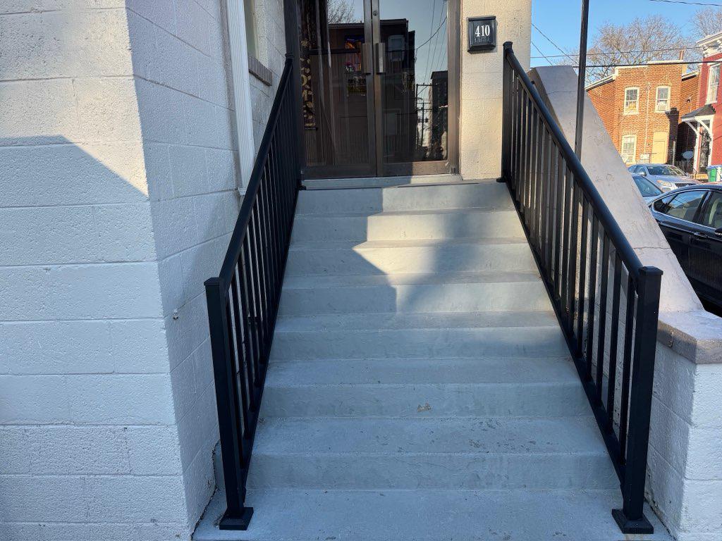 ornamental metal railing installed by top rail fence