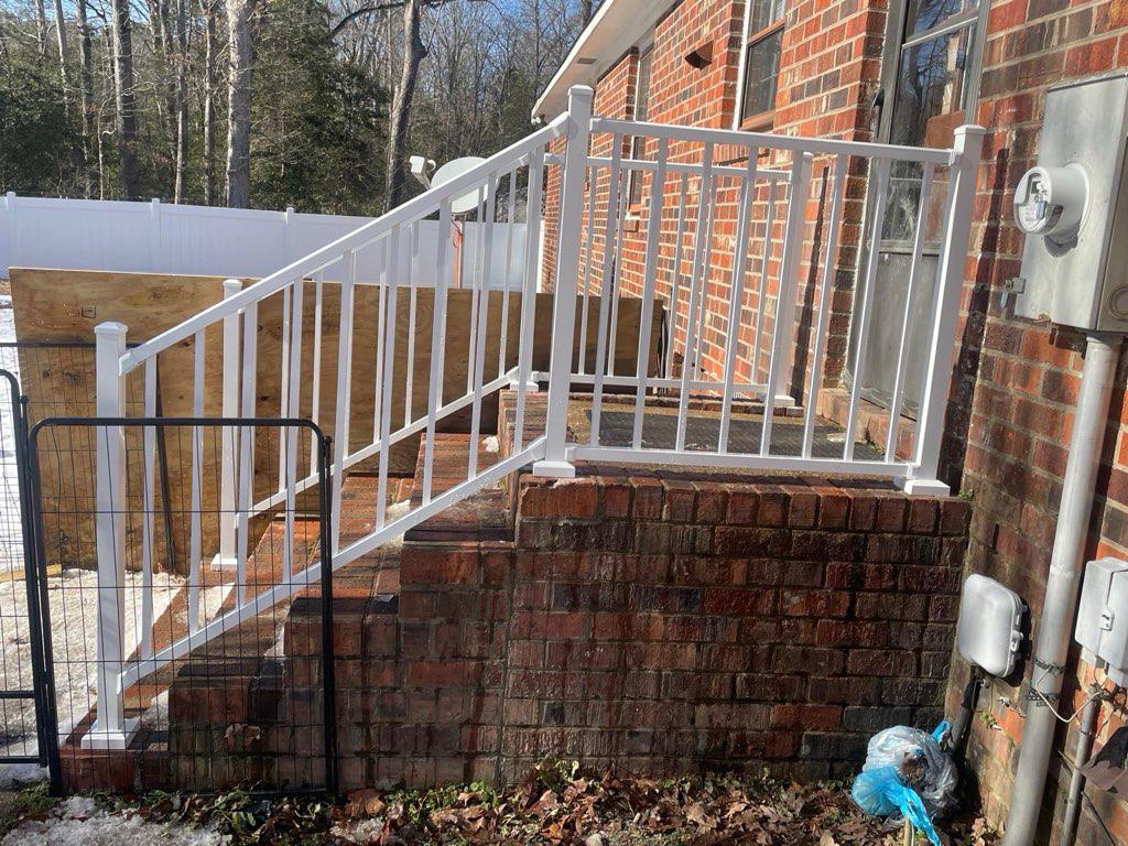 ornamental metal railing installed by top rail fence