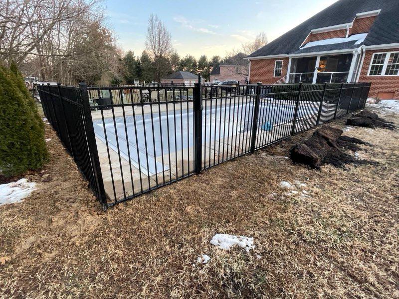 ornamental metal fence installed by top rail fence