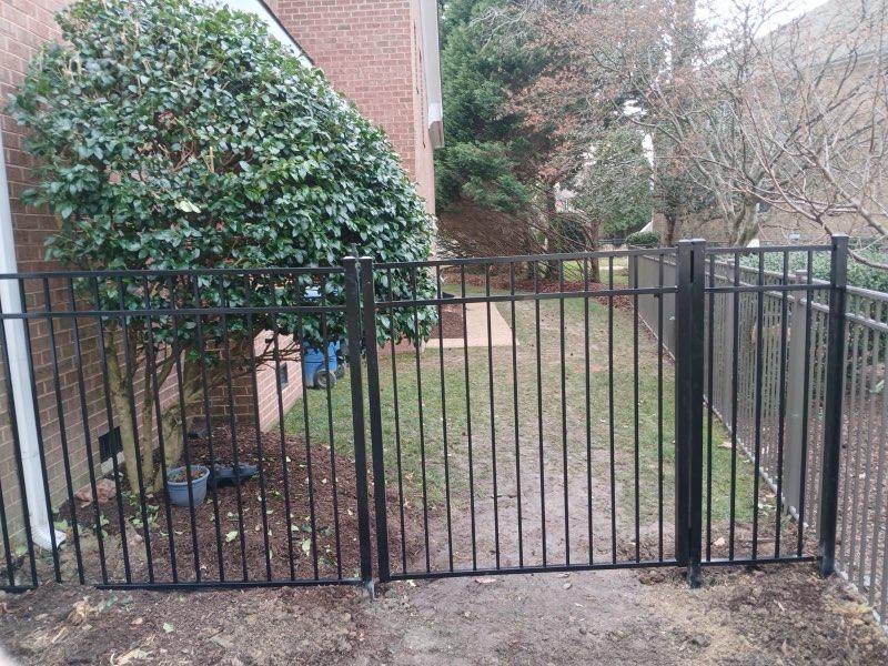 ornamental metal fence installed by top rail fence