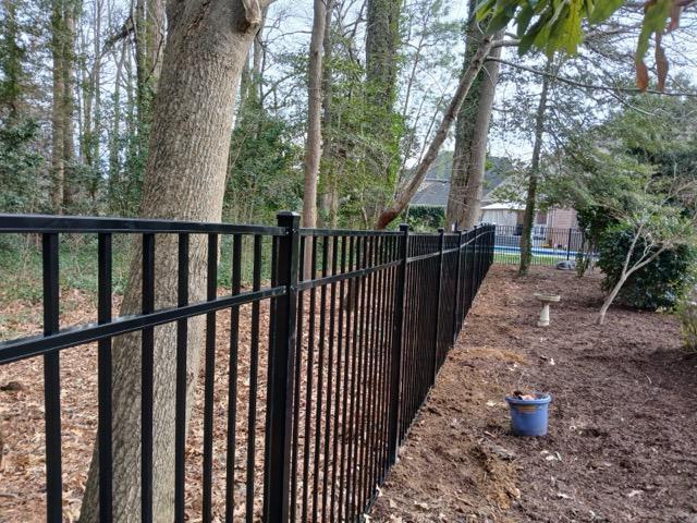 ornamental metal fence installed by top rail fence
