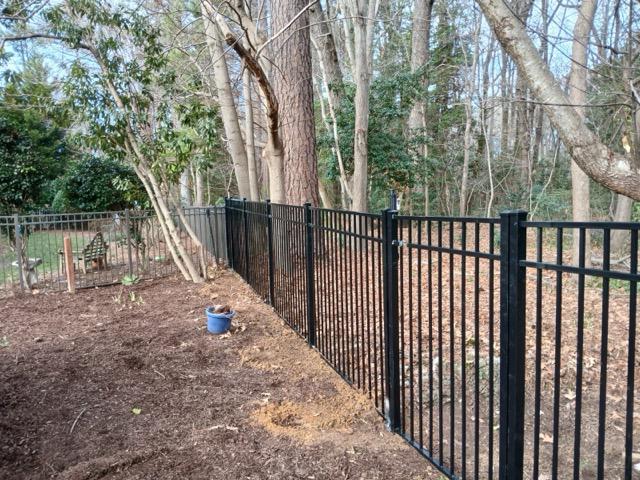 ornamental metal fence installed by top rail fence