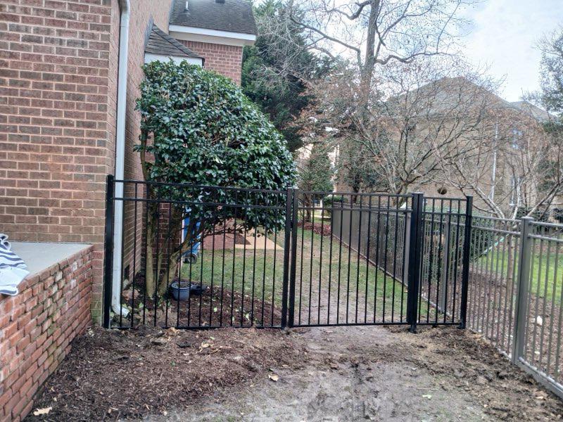 ornamental metal fence installed by top rail fence