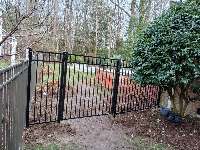 ornamental metal fence installed by top rail fence
