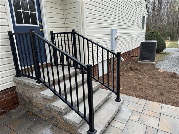 ornamental metal railing installed by top rail fence