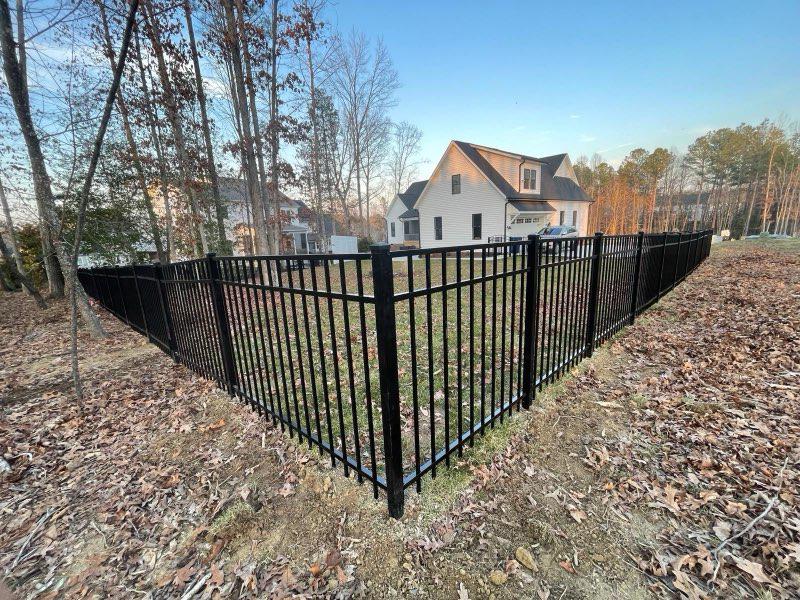 ornamental metal fence installed by top rail fence