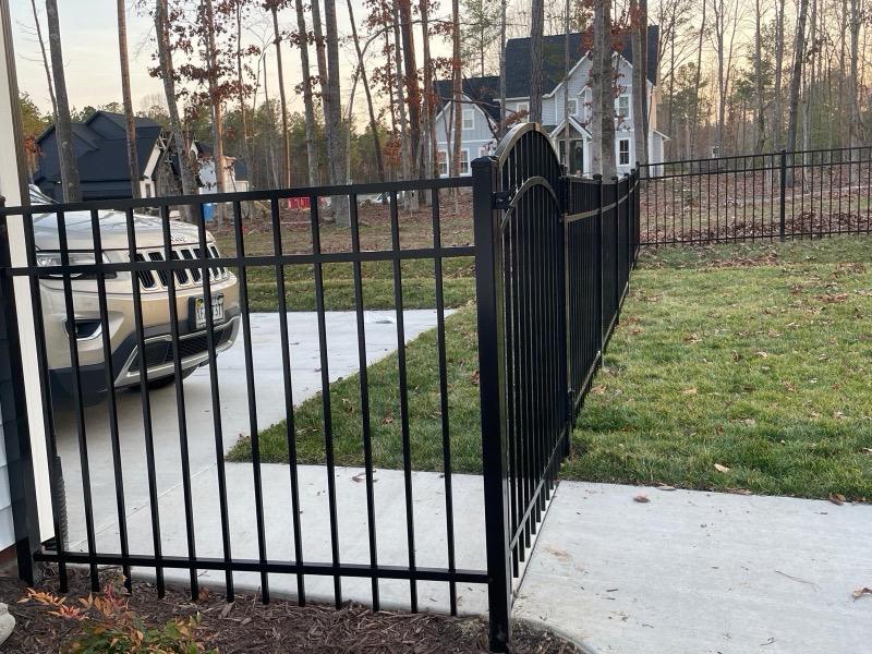 ornamental metal fence installed by top rail fence