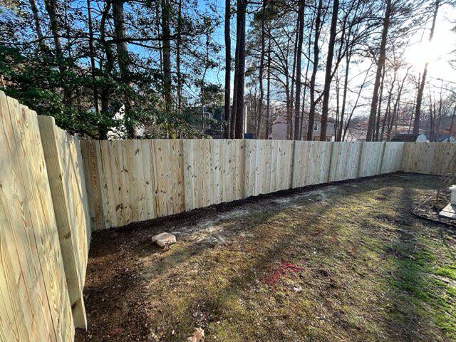 wood stockade fence installed by top rail fence