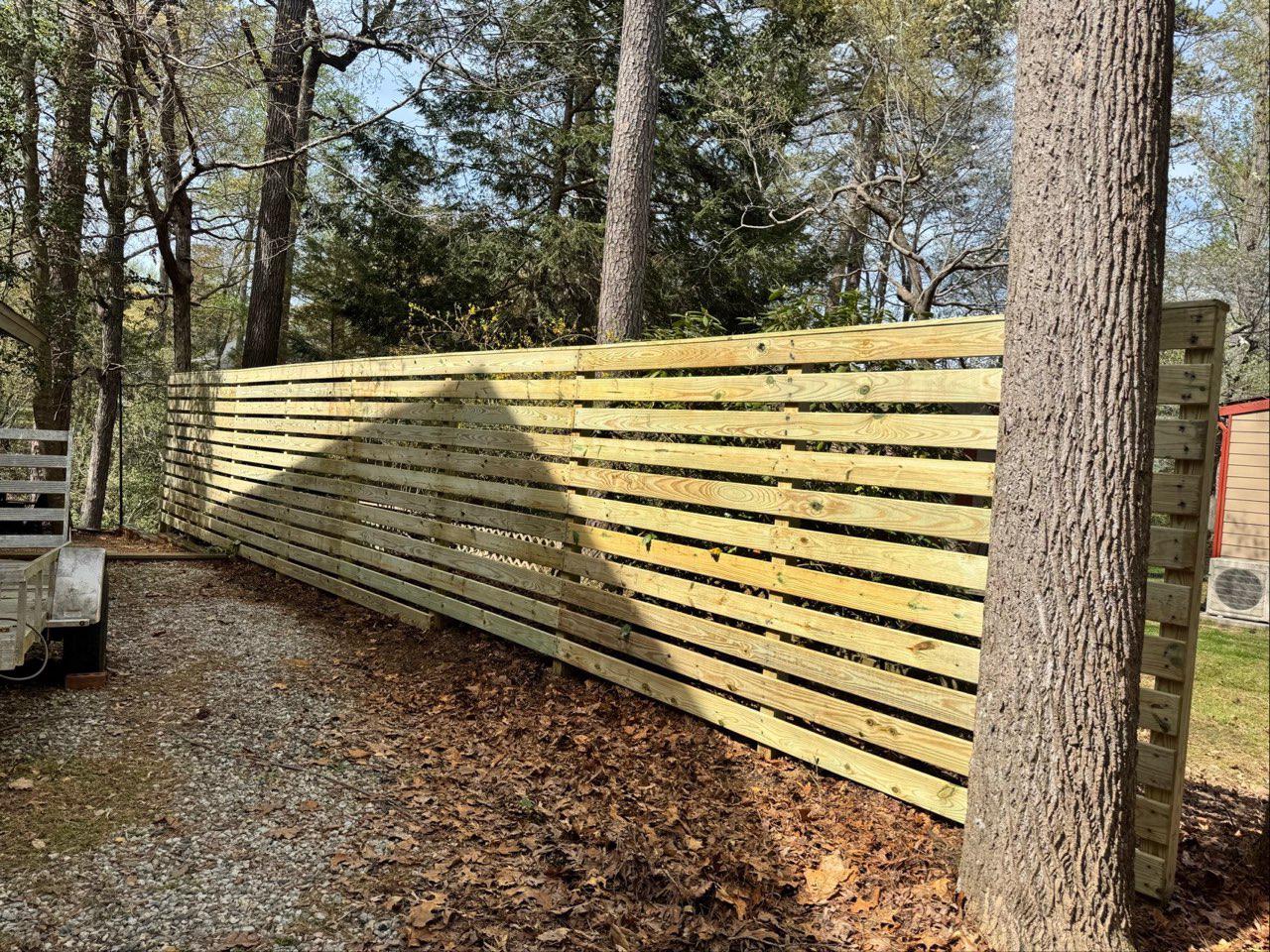 wood horizontal fence installed by top rail fence
