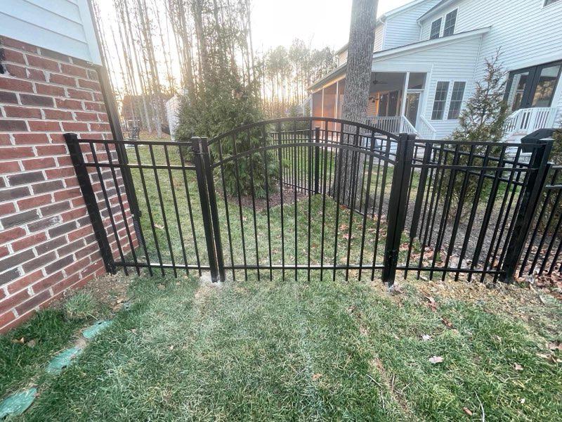ornamental metal fence installed by top rail fence
