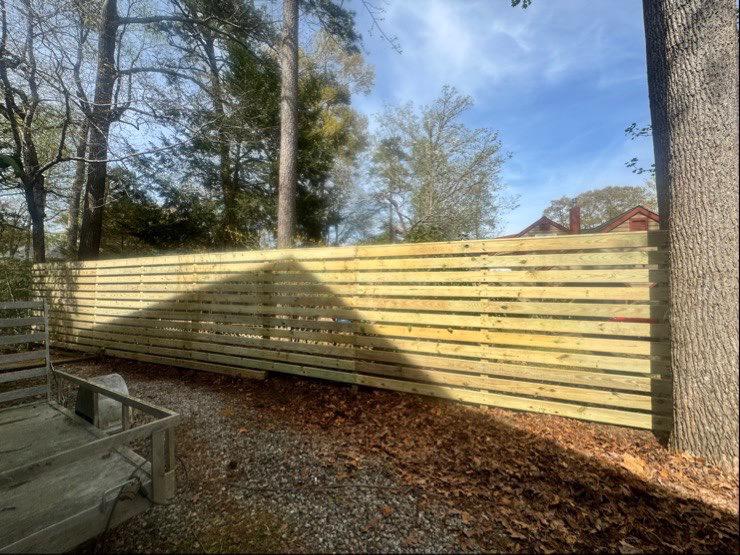 wood fence installed by top rail fence