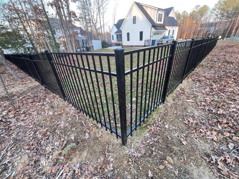 ornamental metal fence installed by top rail fence