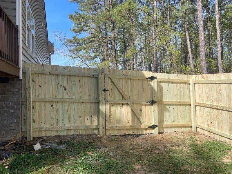 wood stockade fence installed by top rail fence
